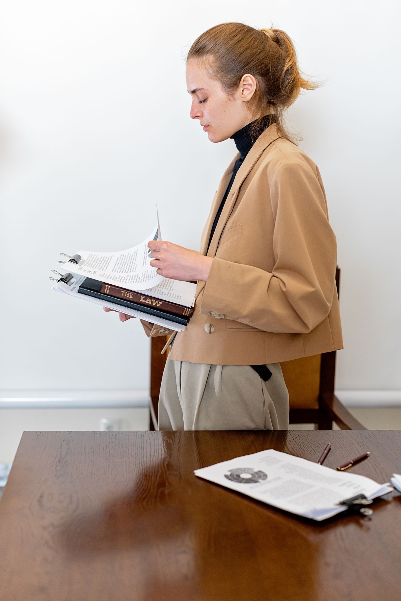 Advogada revisando documentos na mesa do escritório